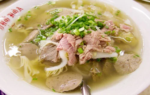 Traditional Vietnamese Beef Pho with fresh herbs